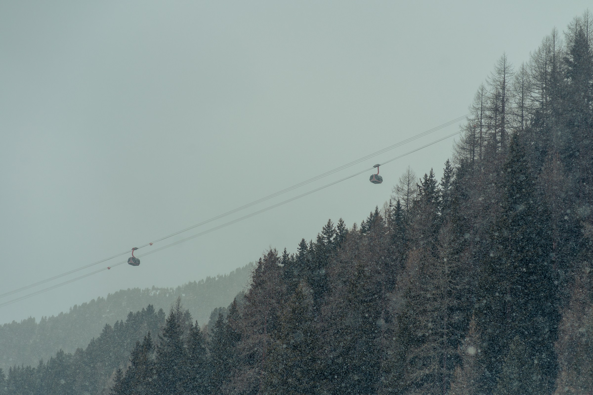 Skier under the stars on a snowy mountain, with a dramatic dark sky